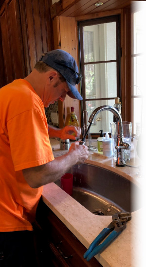 residential plumber working on a sink